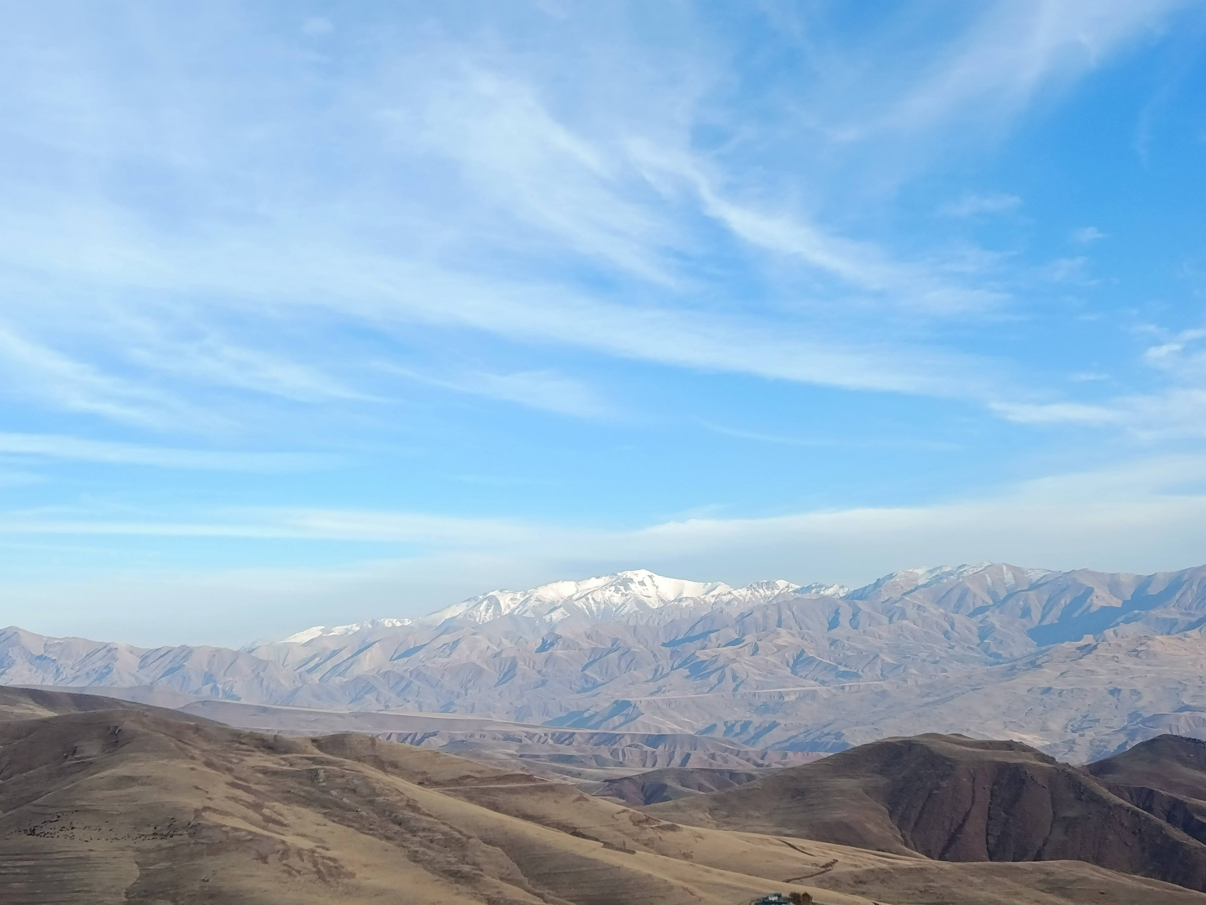 Snowy mountain range and golden foothills